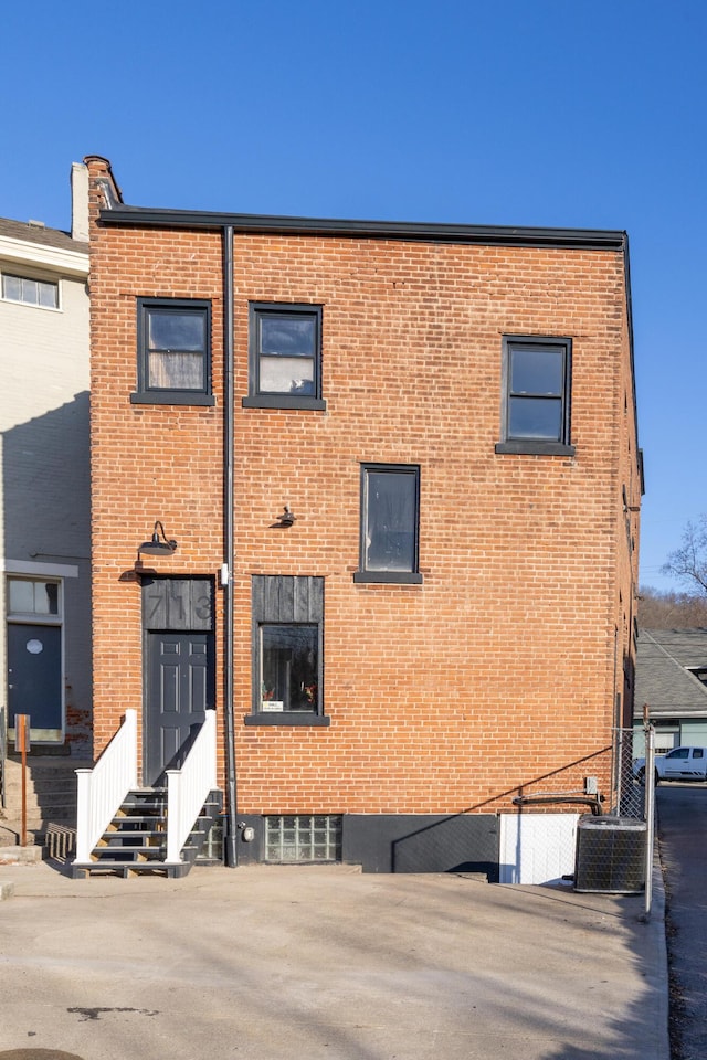 view of building exterior with cooling unit and entry steps