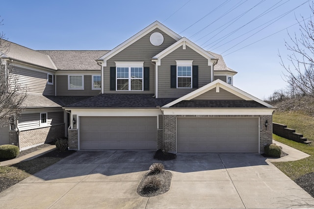 view of front of house featuring brick siding, concrete driveway, an attached garage, and a shingled roof