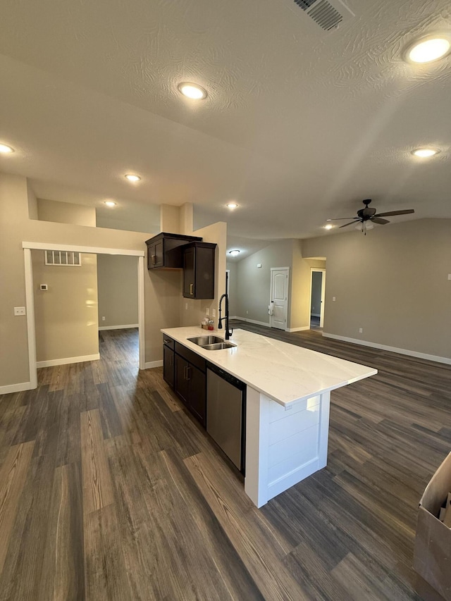 kitchen featuring visible vents, dishwasher, dark wood-type flooring, and a sink