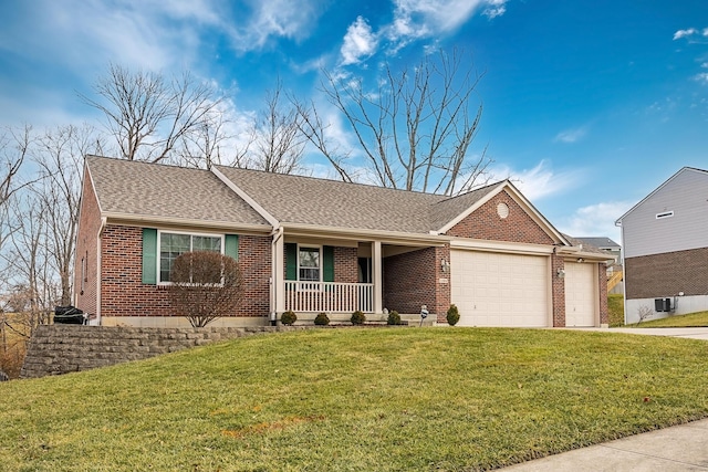 ranch-style house featuring a porch, a front yard, brick siding, and an attached garage