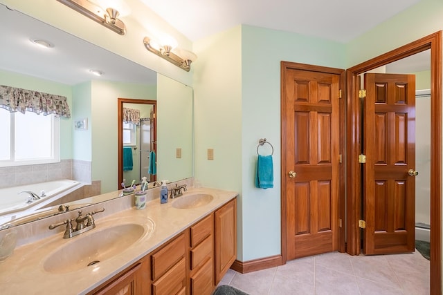 bathroom featuring double vanity, a sink, a washtub, and tile patterned floors