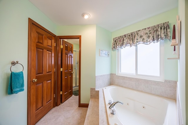 bathroom with a jetted tub and tile patterned floors