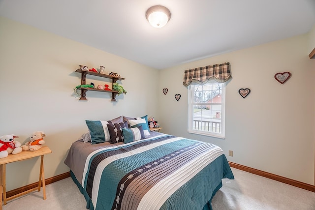 bedroom with light carpet and baseboards