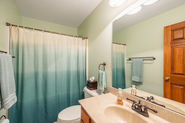 bathroom featuring toilet, curtained shower, and vanity