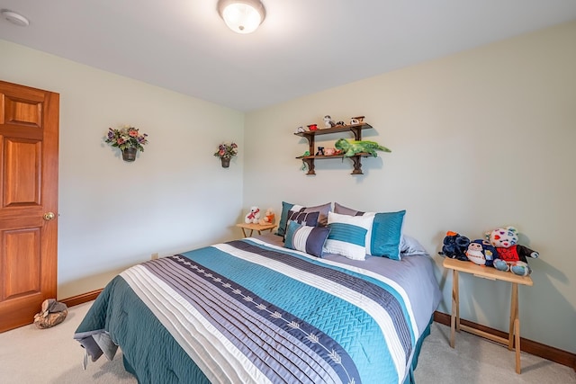 bedroom with baseboards and light colored carpet