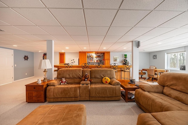 living room with a paneled ceiling, light colored carpet, baseboards, and recessed lighting