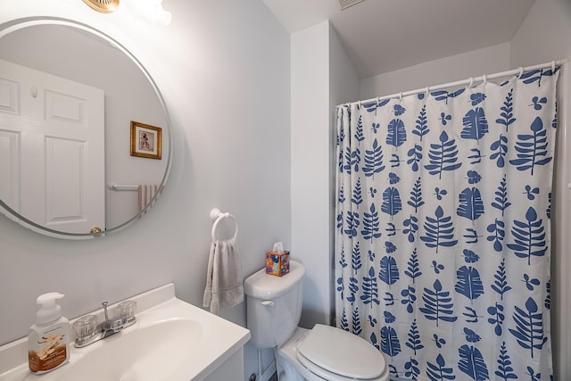 bathroom featuring toilet, visible vents, vanity, and a shower with curtain