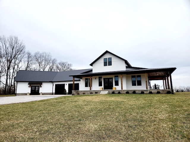 modern farmhouse with a porch, a front yard, metal roof, driveway, and an attached garage