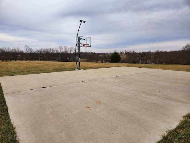 view of basketball court with a yard and community basketball court