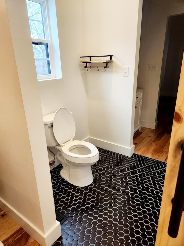 bathroom with toilet and baseboards