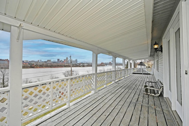 wooden deck featuring a city view and a water view