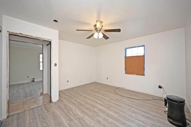 empty room featuring a ceiling fan and wood finished floors