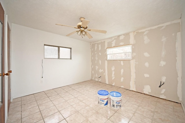 spare room with ceiling fan and a textured ceiling