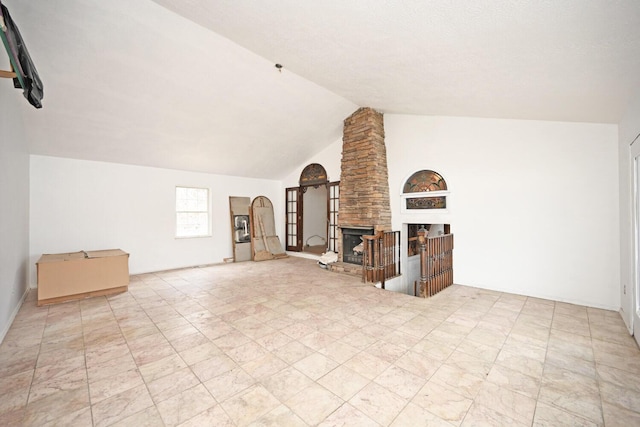 additional living space with high vaulted ceiling and a stone fireplace