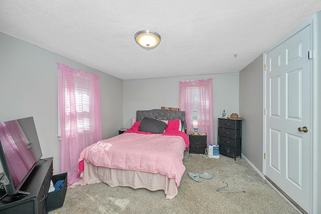 carpeted bedroom with a textured ceiling