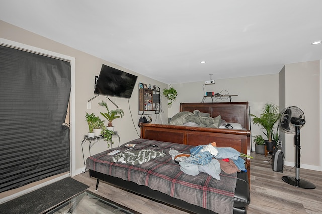 bedroom with recessed lighting, baseboards, and wood finished floors