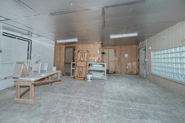 interior space featuring concrete floors and a sink