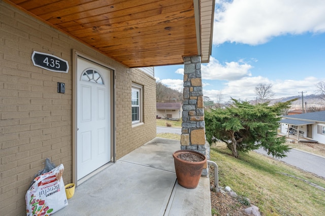 property entrance featuring brick siding