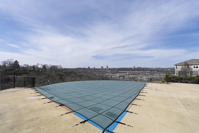 view of swimming pool featuring fence