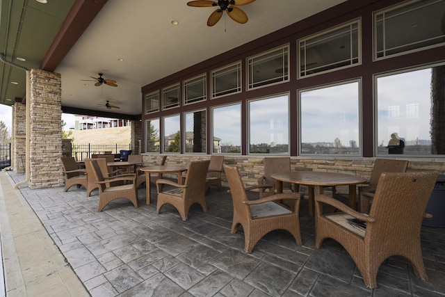 sunroom featuring a ceiling fan