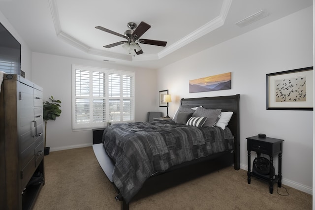 carpeted bedroom with crown molding, a raised ceiling, visible vents, a ceiling fan, and baseboards