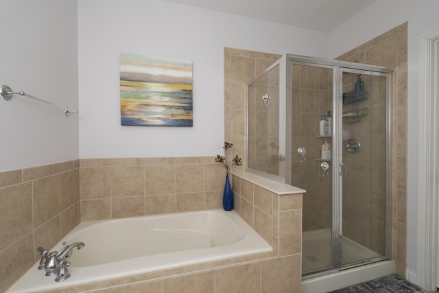 full bath featuring a garden tub and a shower stall