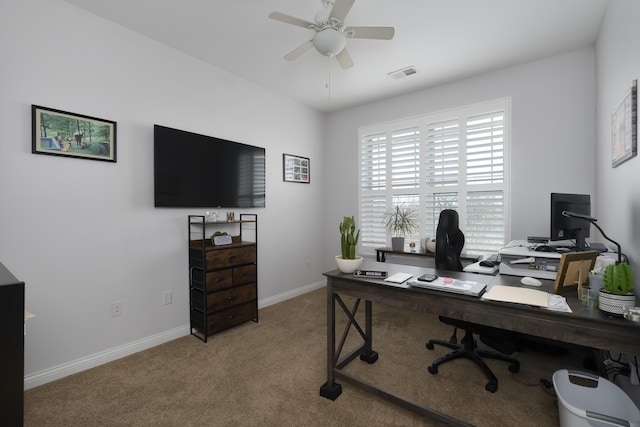 office space with carpet floors, baseboards, visible vents, and a ceiling fan