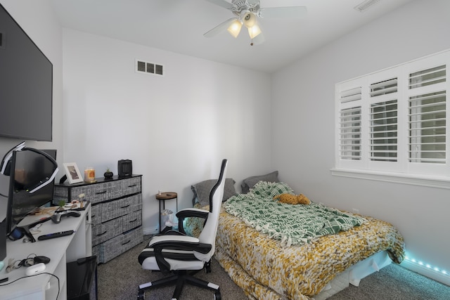 carpeted bedroom featuring visible vents and a ceiling fan