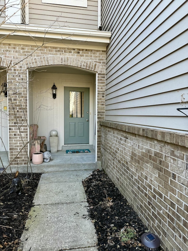 property entrance with brick siding