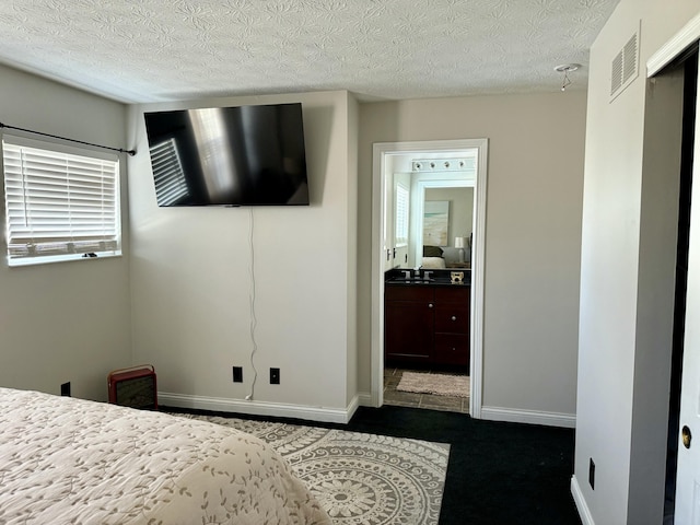 bedroom with visible vents, a textured ceiling, and a sink