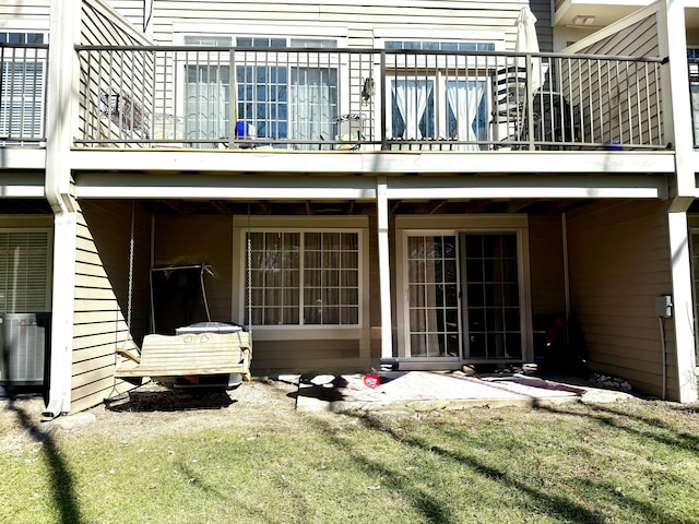 back of house featuring a balcony and central AC unit