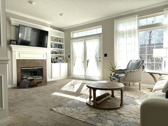 carpeted living room featuring baseboards, a textured ceiling, ornamental molding, and a fireplace