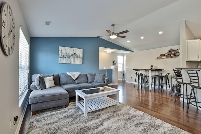 living room with lofted ceiling, wood finished floors, recessed lighting, baseboards, and ceiling fan