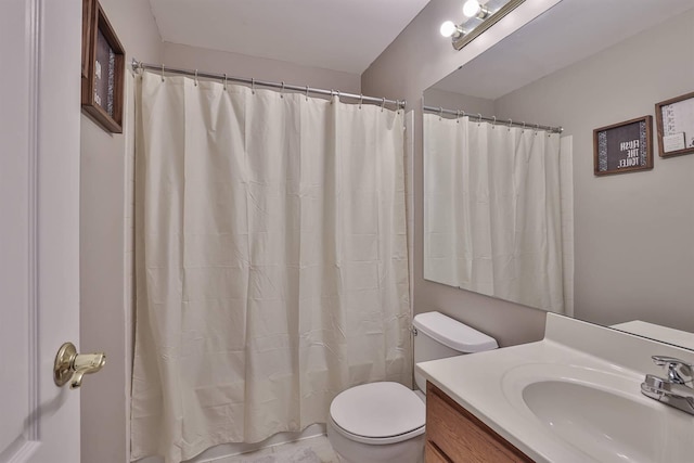 bathroom featuring toilet and vanity