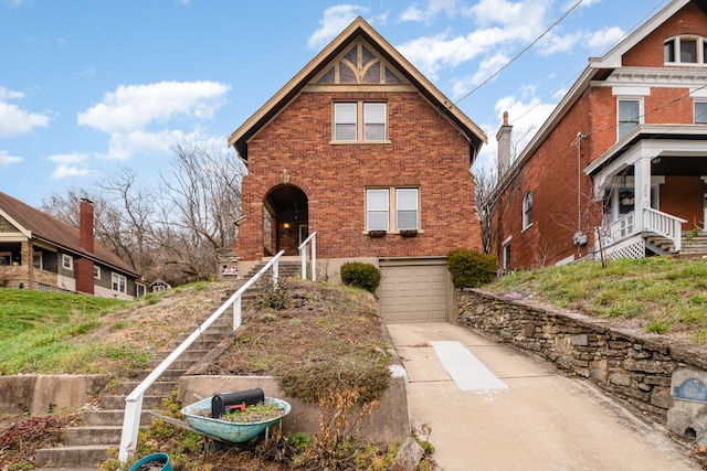 view of front of property featuring a garage, stairway, concrete driveway, and brick siding