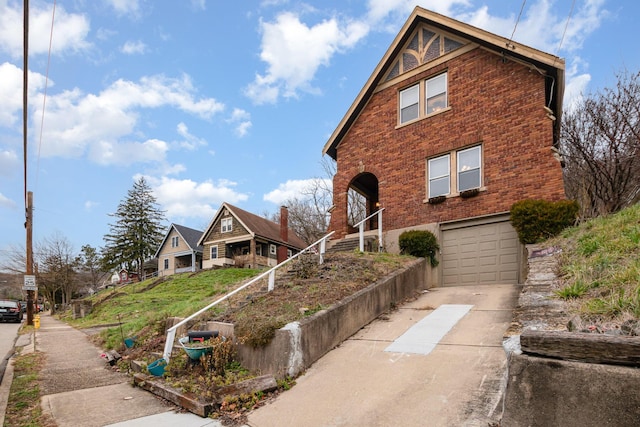 view of front of home with brick siding, driveway, and an attached garage