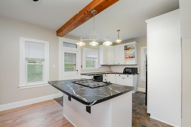 kitchen featuring white cabinetry, decorative backsplash, open shelves, beamed ceiling, and dark countertops