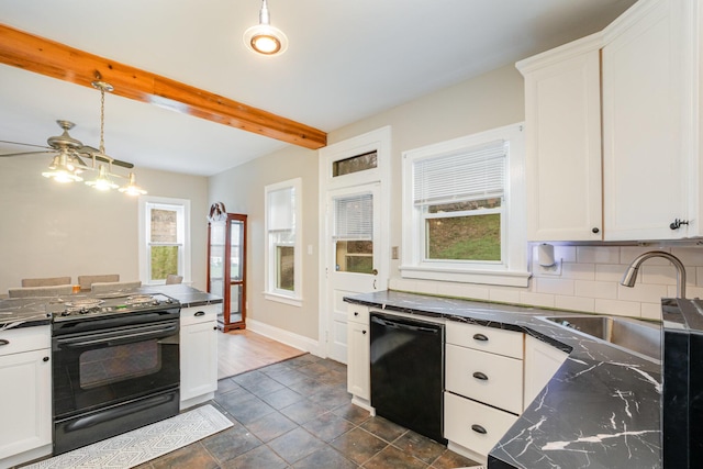 kitchen featuring dark countertops, black appliances, a healthy amount of sunlight, and a sink