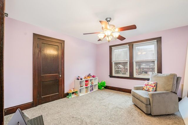 recreation room with carpet floors, baseboards, and a ceiling fan