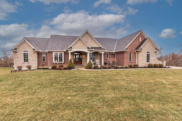 view of front of property featuring stone siding and a front yard