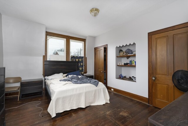 bedroom featuring baseboards and wood-type flooring