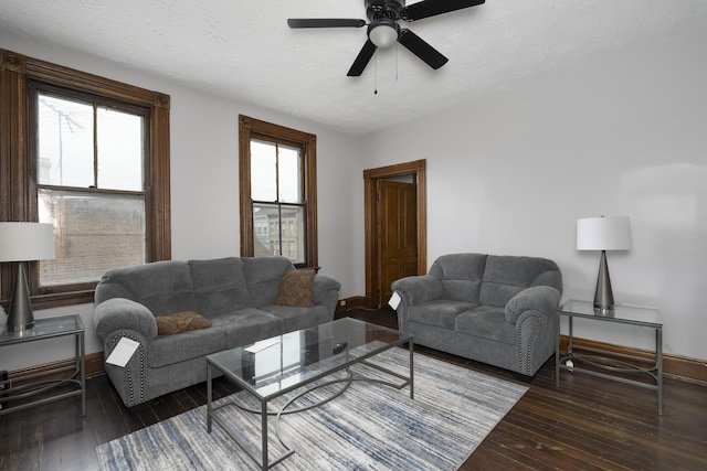 living room with ceiling fan, hardwood / wood-style flooring, baseboards, and a textured ceiling