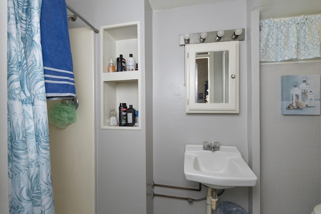 full bathroom with a shower with shower curtain and a sink