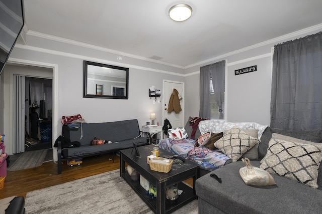 living area featuring wood finished floors and ornamental molding