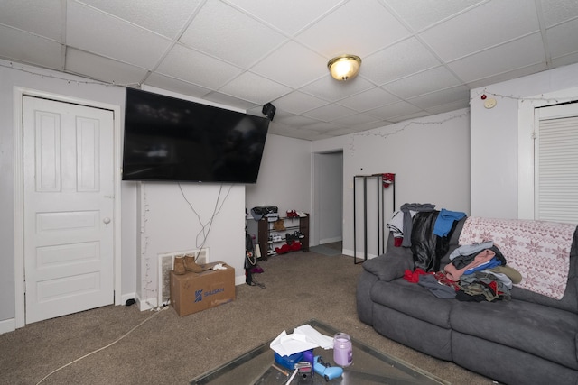 carpeted living area featuring a paneled ceiling