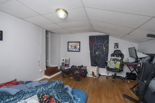 bedroom featuring a paneled ceiling and wood finished floors