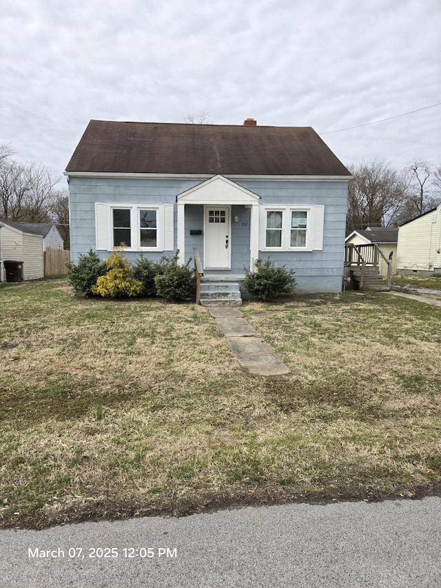 bungalow-style home with a front lawn