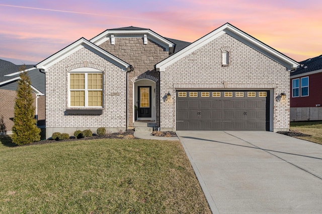 view of front facade with concrete driveway, a front lawn, an attached garage, and brick siding