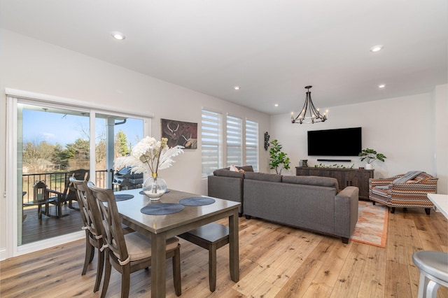 dining space featuring an inviting chandelier, plenty of natural light, light wood finished floors, and recessed lighting