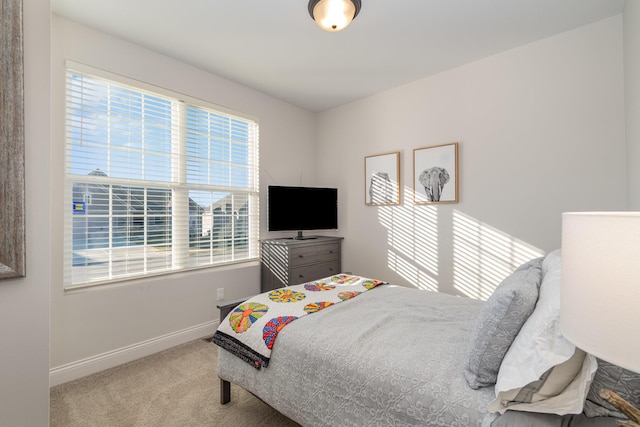 bedroom with baseboards and carpet flooring